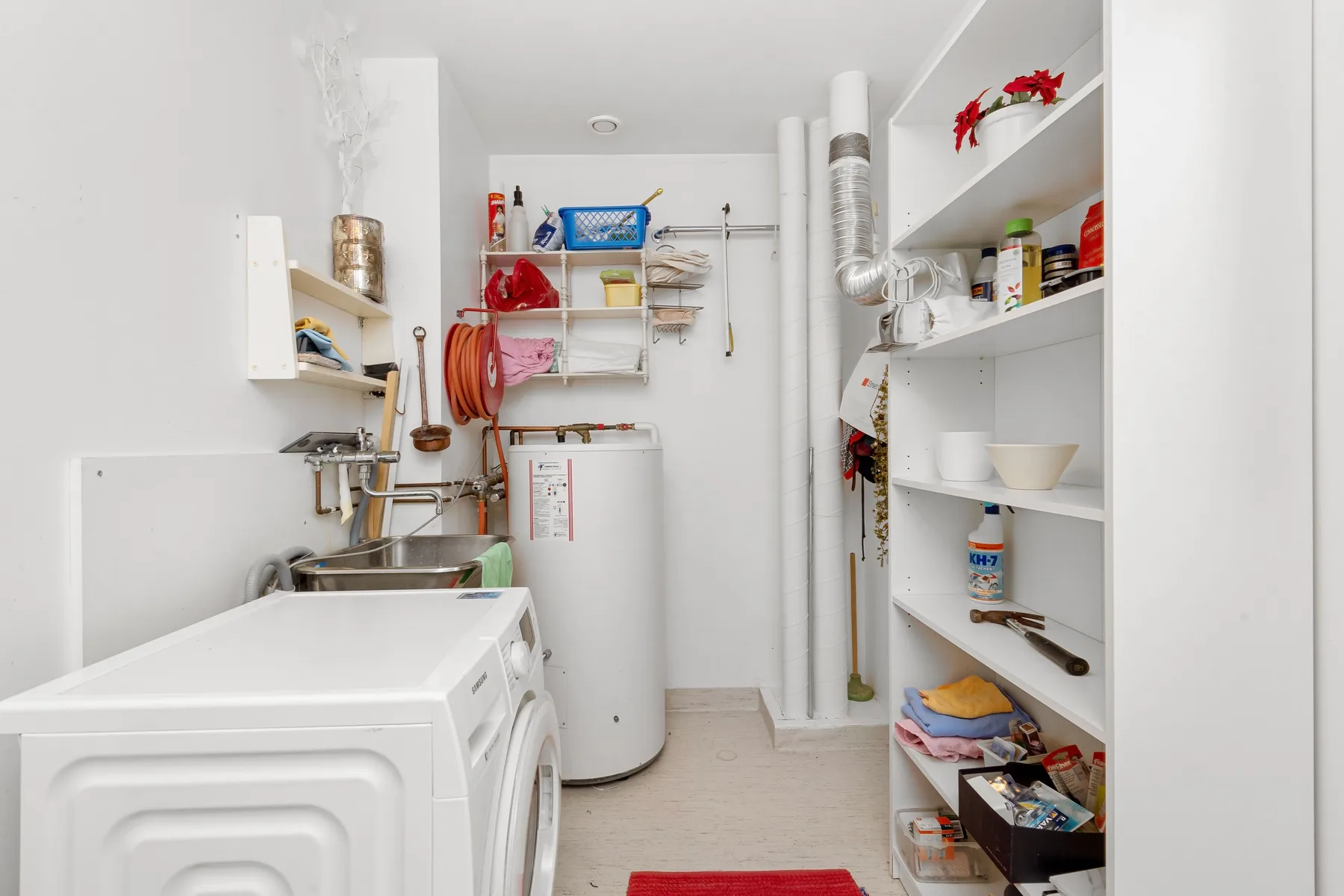 Stock photo of a utility room with a water heater